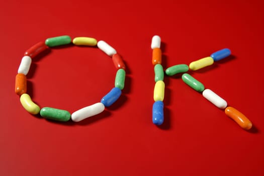 Candy colorful sweets with letter shapes spelling the word OK