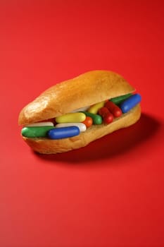 Sandwich made of colorful candy sweet, children favourites menu over red