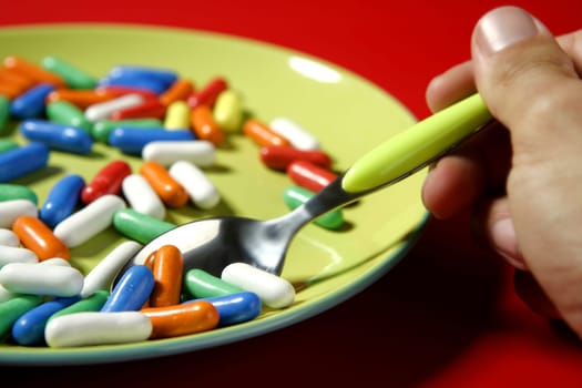 Children favourite menu, sweet colorful little candy in green plate
