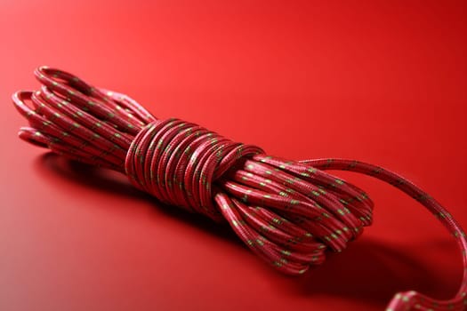 Red thread spool on monochrome background