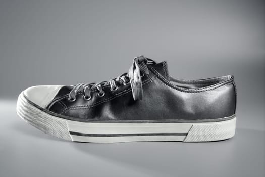 Silver gray sport shoe side view studio shot