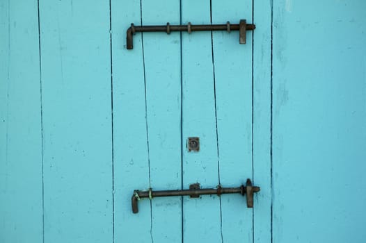 Aged wooden color door in mediterranean area. Spain