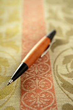 Designer black and wooden pencil, selective focus on tablecloth