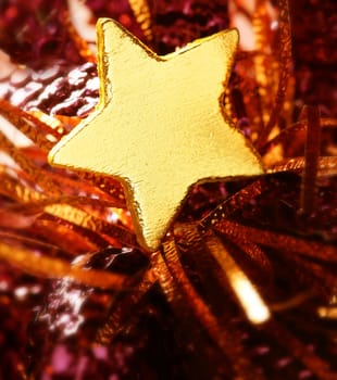 Christmas golden decoration with gold star over red background