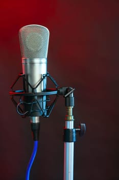 Microphone in the night colorful light in a recording studio