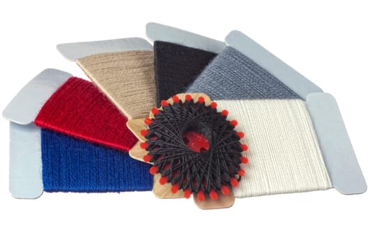 a few strands of darning colored on white background