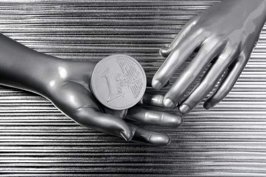 silver euro coins in futuristic robot gray metallic hands bank metaphor