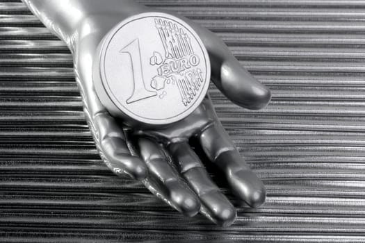 euro silver coin of futuristic metallic silver hand money metaphor