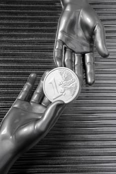 silver euro coins in futuristic robot gray metallic hands bank metaphor