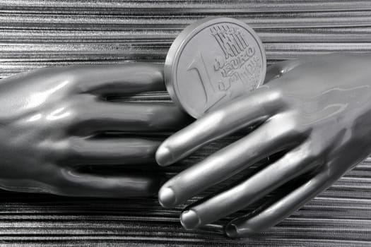 silver euro coins in futuristic robot gray metallic hands bank metaphor
