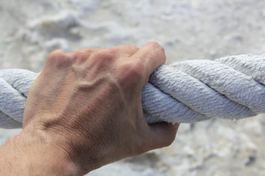 man hand grab grip holding strong big aged marine huge rope