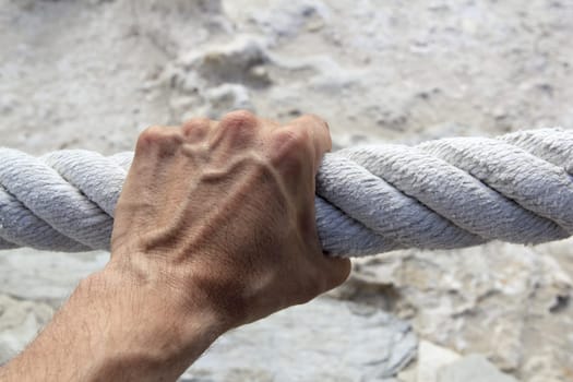 man hand grab grip holding strong big aged marine huge rope
