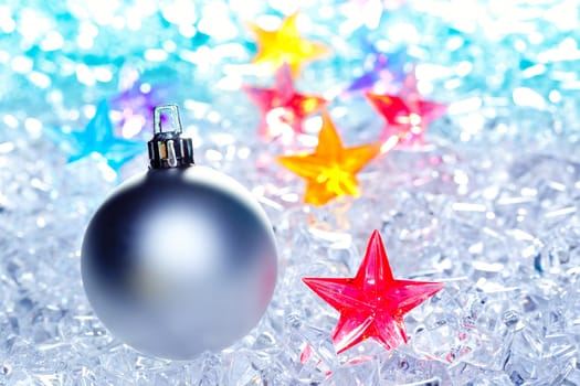 christmas baubles silver on winter ice with star symbol shapes