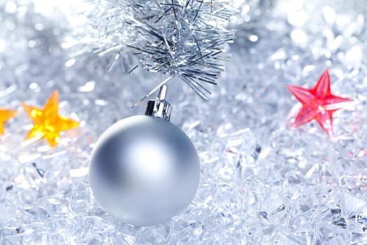 christmas baubles silver on winter ice with star symbol shapes