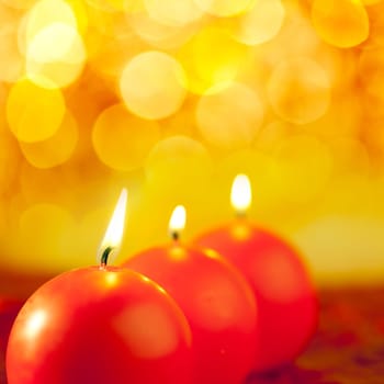 christmas red candles round shape in a row on bokeh golden background