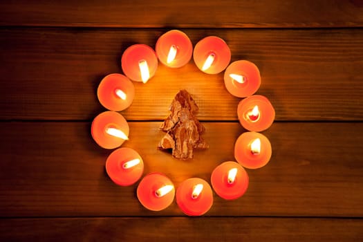 christmas candles circle over wood and bark tree symbol