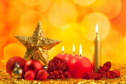christmas golden star with red candles on bokeh lights background