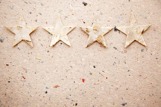 christmas stars on recycled paper background as an ecology metaphor