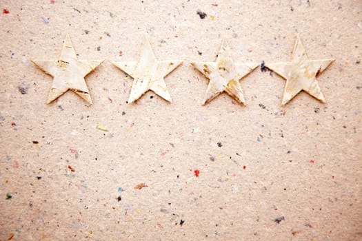christmas stars on recycled paper background as an ecology metaphor