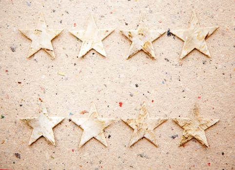 christmas stars on recycled paper background as an ecology metaphor