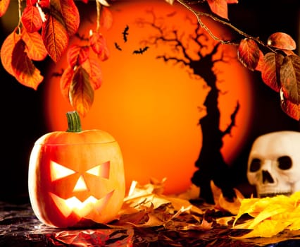 Halloween orange pumpkin lantern with autumn leaves