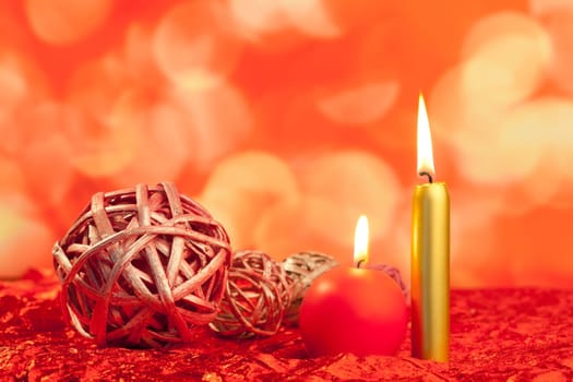 christmas candles with dried baubles on red lights background