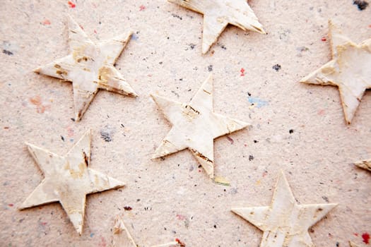 christmas stars on recycled paper background as an ecology metaphor