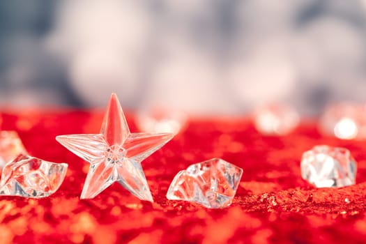 Christmas crystal star on ice cubes with blue lights bokeh background