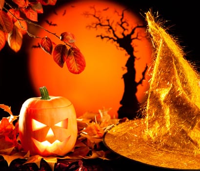 Halloween orange pumpkin lantern with autumn leaves