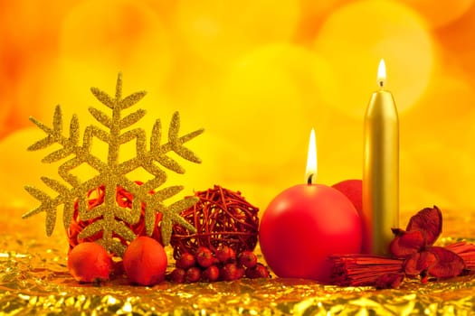 christmas golden snowflake with red candles on bokeh lights background