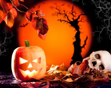 Halloween orange pumpkin lantern with autumn leaves