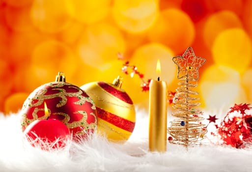christmas wire tree with candle and baubles in blurred lights background