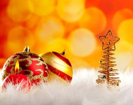 christmas wire tree with candle and baubles in blurred lights background