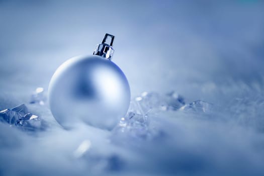 christmas silver bauble on fur snow and ice cold winter