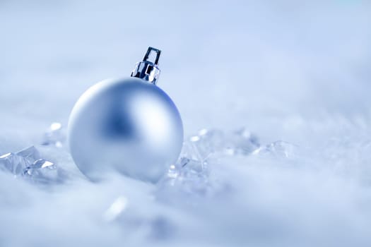 christmas silver bauble on fur snow and ice cold winter