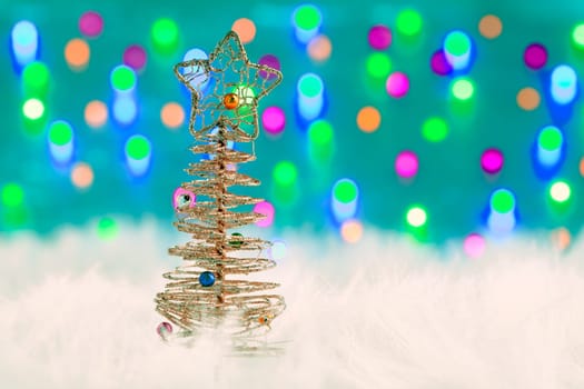 christmas wire tree on white fur and colorful lights