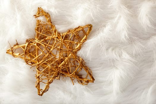 Christmas golden star over white fur background