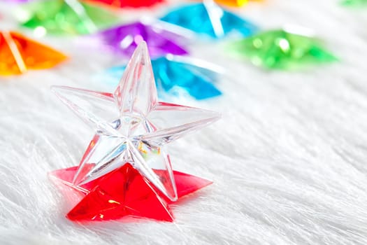 Christmas glass star over winter white fur background