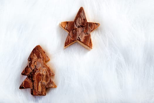 Christmas tree and star over white fur background as snow