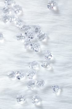 crystal ice cubes on winter white fur background