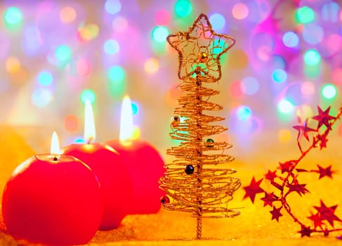 Christmas golden tree with baubles and candles in blur lights