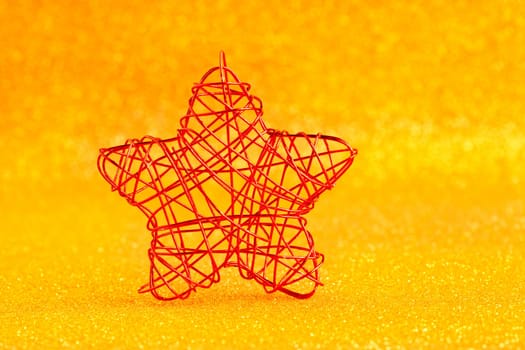 christmas golden star of wire over golden glitter background