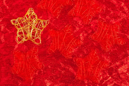 christmas golden star of wire over red background