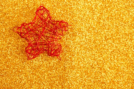 christmas golden star of wire over golden glitter background