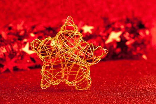 christmas gold wire star on red glitter background