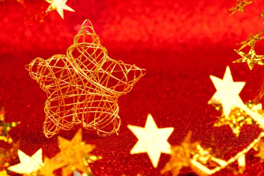 christmas gold wire star on red glitter background