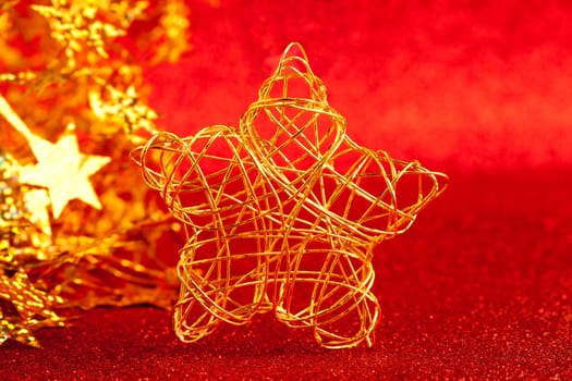 christmas gold wire star on red glitter background
