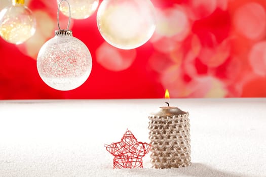christmas silver candle and red star on snow and red with glass baubles