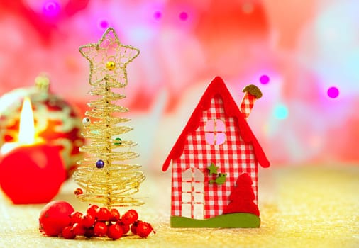 Christmas golden tree and red vichy house in blurred lights