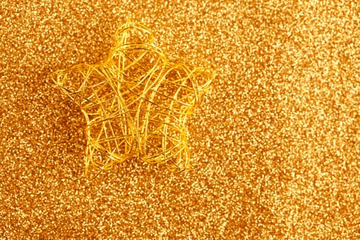 christmas gold wire star on golden glitter background